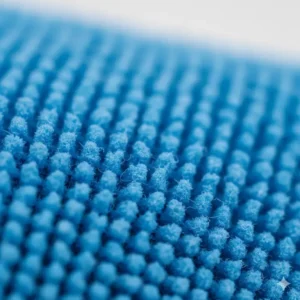 Close-up texture of the interwoven fabric to show the ultra-fine material used to make the best microfiber eyeglass cleaning cloth.