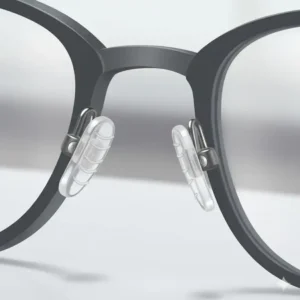 Detailed view of the silicone non-slip nose pads design on the bridge of an eyeglass frame.