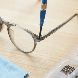 Using mini precision screwdrivers as essential tools to fix glasses by tightening loose frame screws.