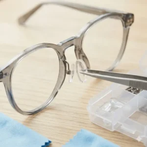 Tweezers and new nose pads shown as necessary tools to fix glasses and improve comfort.