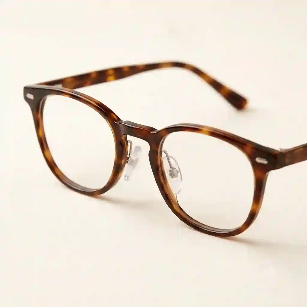 A close-up shot of premium silicone glasses bridge pad attached to a pair of modern tortoiseshell eyeglasses.